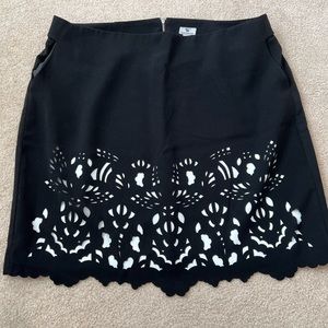 Black Pencil skirt with cut-out design. White lining. Scalloped hem. Never worn